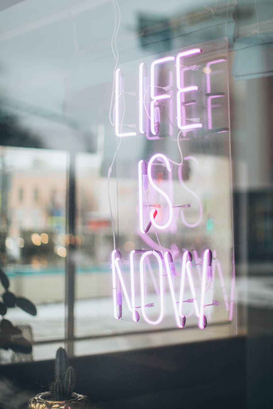 neon sign reading Life is Now